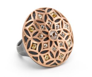 A ring with a flower design and some stones